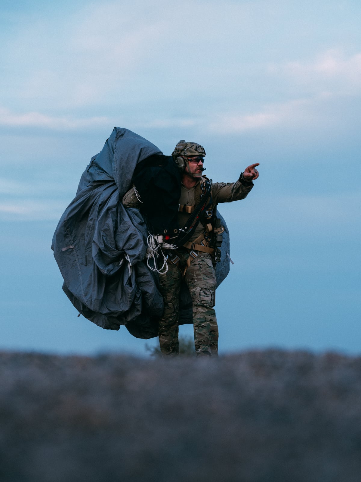 Outer Heaven operator with parachute pack at dusk after canopy ride